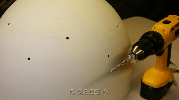 Glue holes are marked and drilled on the inner dome between the upper and lower panel openings.