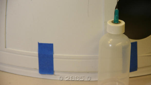 Turn the dome upside down and glue the bottom edge first between the tape. After the glue sets, remove tape and finish gluing.