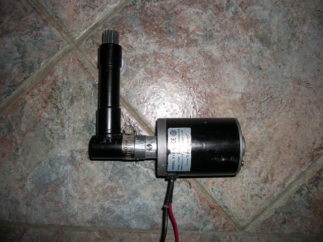 Prototype 130 Watt scooter motor and right angle drill adapter with cog wheel.